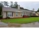 Well-maintained exterior view of the home with a manicured lawn, shutters, and partial brick accents at 179 Camry Ln, Grayson, GA 30017