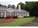 Well-maintained ranch home with manicured lawn, mature trees, and inviting curb appeal at 179 Camry Ln, Grayson, GA 30017