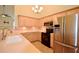 Well-equipped kitchen with light wood cabinets, stainless steel appliances, and tile backsplash at 179 Camry Ln, Grayson, GA 30017