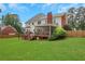 Expansive backyard featuring a screened porch, wooden deck, and lush green lawn, perfect for outdoor living at 2535 Winthrope Way, Lawrenceville, GA 30044