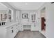Bathroom featuring marble countertops, dual sinks, storage, and modern mirrors at 2535 Winthrope Way, Lawrenceville, GA 30044