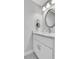 Stylish bathroom featuring a white vanity with a marble countertop and an oval mirror at 2535 Winthrope Way, Lawrenceville, GA 30044