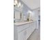 Bright bathroom with white double vanity, tiled floors, and updated lighting at 2535 Winthrope Way, Lawrenceville, GA 30044