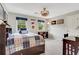 Comfortable bedroom featuring hardwood floors, a ceiling fan, and plenty of natural light at 2535 Winthrope Way, Lawrenceville, GA 30044