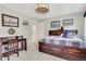 Bright bedroom featuring carpeting, a modern ceiling fan, and a large desk at 2535 Winthrope Way, Lawrenceville, GA 30044