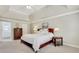 Bright bedroom with tray ceilings, a large bed, and a window with natural light at 2535 Winthrope Way, Lawrenceville, GA 30044
