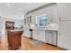An eat-in kitchen featuring white cabinets, stainless appliances, hardwood floors and an island at 2535 Winthrope Way, Lawrenceville, GA 30044