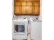 Well-organized laundry room with modern washer and dryer beneath wooden cabinets at 2535 Winthrope Way, Lawrenceville, GA 30044