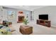 Inviting living room featuring a brick fireplace, built-in shelving, and lots of natural light at 2535 Winthrope Way, Lawrenceville, GA 30044