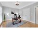 Bright office space with hardwood floors, rug, modern desk, chair, and decorative lighting at 2535 Winthrope Way, Lawrenceville, GA 30044