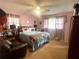 Bedroom featuring a ceiling fan, large window, and leather sofa at 3750 Dial Mill Ne Rd, Conyers, GA 30013