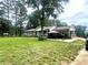 Charming single story home with a well-manicured front yard, mature trees, and welcoming outdoor seating area at 3750 Dial Mill Ne Rd, Conyers, GA 30013