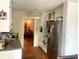 Functional kitchen featuring bright white cabinets, stainless steel refrigerator, and a view into the dining area at 3750 Dial Mill Ne Rd, Conyers, GA 30013
