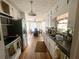 Efficient kitchen with bright white cabinets, stainless appliances, and an adjacent dining area at 3750 Dial Mill Ne Rd, Conyers, GA 30013