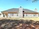 Home exterior from the rear showing chimney, windows and vinyl siding at 40 Pebble Brooke Ct, Covington, GA 30016