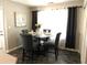 Dining room features a modern black table with seating for four, and a large window at 40 Pebble Brooke Ct, Covington, GA 30016