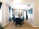 Dining room boasts elegant decor, including a chandelier and blue velvet chairs at 40 Pebble Brooke Ct, Covington, GA 30016