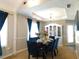 Dining room with a glass table, blue velvet chairs, and stylish decorations at 40 Pebble Brooke Ct, Covington, GA 30016