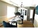 Bright dining room with elegant chandelier, modern table setting, and built-in china cabinet at 40 Pebble Brooke Ct, Covington, GA 30016