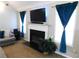 Living room showcasing a fireplace with a white mantel and a mounted TV at 40 Pebble Brooke Ct, Covington, GA 30016