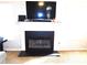 Close-up of a white fireplace with a black firebox and mantel; room has neutral color at 40 Pebble Brooke Ct, Covington, GA 30016