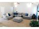 Living room featuring a large, comfortable sectional sofa and neutral decor at 40 Pebble Brooke Ct, Covington, GA 30016