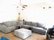 Open living room with vaulted ceilings, a plush grey sectional, and warm, inviting decor at 40 Pebble Brooke Ct, Covington, GA 30016