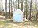 Outdoor shed for extra storage space in a wooded backyard setting at 40 Pebble Brooke Ct, Covington, GA 30016