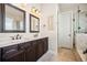 Spacious bathroom featuring a double vanity, large mirrors, and a glass-enclosed shower at 4155 Brookview Dr, Cumming, GA 30040