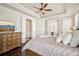 Comfortable main bedroom features trey ceiling, wood floors, and ensuite bath with doors to closet area at 4155 Brookview Dr, Cumming, GA 30040