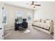 Well-lit bedroom with desk, daybed, carpet, and multiple windows for natural light at 4155 Brookview Dr, Cumming, GA 30040