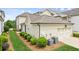 Exterior view of the home's attached garage and manicured landscaping at 4155 Brookview Dr, Cumming, GA 30040