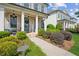 Inviting front porch with brick facade, manicured landscaping, and charming house number at 4155 Brookview Dr, Cumming, GA 30040