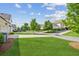 The home has a well manicured front yard with mature trees and lovely green grass at 4155 Brookview Dr, Cumming, GA 30040