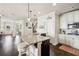 Open-concept kitchen featuring a granite island, modern appliances, and dark hardwood flooring at 4155 Brookview Dr, Cumming, GA 30040