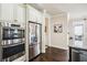 Modern kitchen equipped with stainless steel appliances, bright white cabinets, and seamless flow to dining area at 4155 Brookview Dr, Cumming, GA 30040