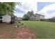 Spacious backyard featuring lawn, playset, chicken coop and a few chickens at 5 White Pines Dr, Dallas, GA 30157