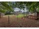 Spacious fenced-in backyard with fire pit, chicken coop and chickens at 5 White Pines Dr, Dallas, GA 30157