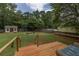 Spacious backyard featuring a wood deck, chicken coop, fire pit and lush lawn at 5 White Pines Dr, Dallas, GA 30157