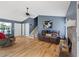 Bright living room featuring hardwood floors, stone fireplace, and a comfortable brown sofa at 5 White Pines Dr, Dallas, GA 30157
