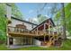 Multi-level wooden deck, perfect for outdoor entertaining, with a view of a lush, green backyard at 950 Ivy St, Cumming, GA 30041