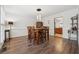 Elegant dining room featuring wood floors, dining table and modern lighting at 950 Ivy St, Cumming, GA 30041
