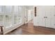 Hallway with wood flooring leading to a sunroom with a beautiful view at 950 Ivy St, Cumming, GA 30041