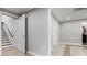 Finished basement featuring neutral paint, tile flooring, and staircase access to the upper level at 108 Faraday Dr, Douglasville, GA 30134
