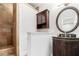 Bathroom vanity with mirror, wood cabinetry and shower at 108 Faraday Dr, Douglasville, GA 30134