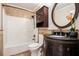 Bathroom with a tub/shower combo, vanity, and dark wood accents at 108 Faraday Dr, Douglasville, GA 30134