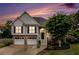 Charming two-story home with a well-manicured front yard at twilight at 108 Faraday Dr, Douglasville, GA 30134