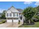 Charming two-story home with a two car garage, stone foundation and a black front door at 108 Faraday Dr, Douglasville, GA 30134