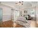 Spacious main bedroom with a tray ceiling, hardwood floors, and a sliding barn door to the bathroom at 108 Faraday Dr, Douglasville, GA 30134