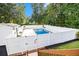Backyard pool is fenced in for safety, surrounded by trees and landscaping at 108 Faraday Dr, Douglasville, GA 30134